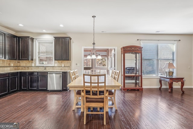 dining room featuring plenty of natural light and dark hardwood / wood-style floors