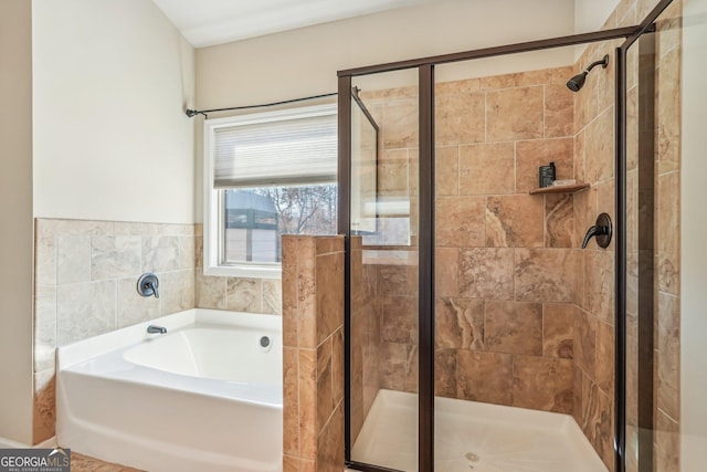 bathroom featuring independent shower and bath