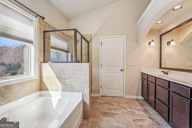 bathroom featuring shower with separate bathtub and vanity