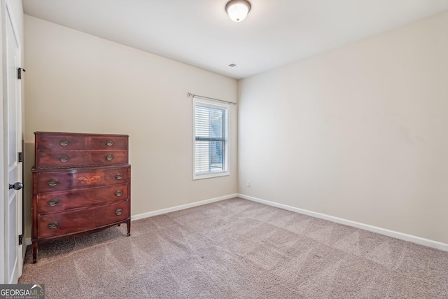 unfurnished bedroom featuring light colored carpet