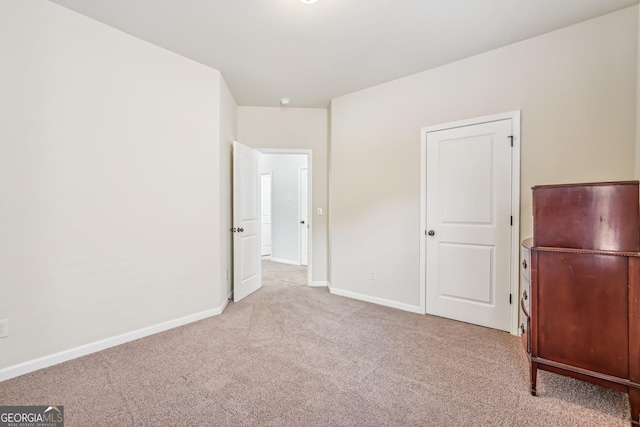 unfurnished bedroom with light colored carpet