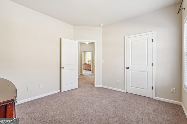 unfurnished bedroom with light colored carpet