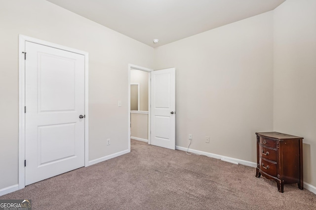 unfurnished bedroom with light colored carpet