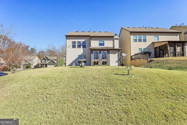 rear view of house with a yard