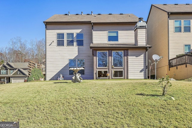 rear view of house with a lawn