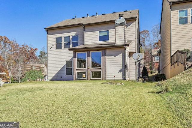 rear view of house with a lawn