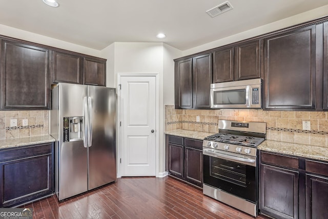 kitchen featuring tasteful backsplash, dark hardwood / wood-style floors, and appliances with stainless steel finishes