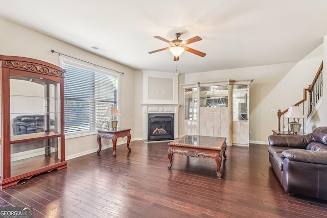 living room featuring dark hardwood / wood-style flooring and ceiling fan