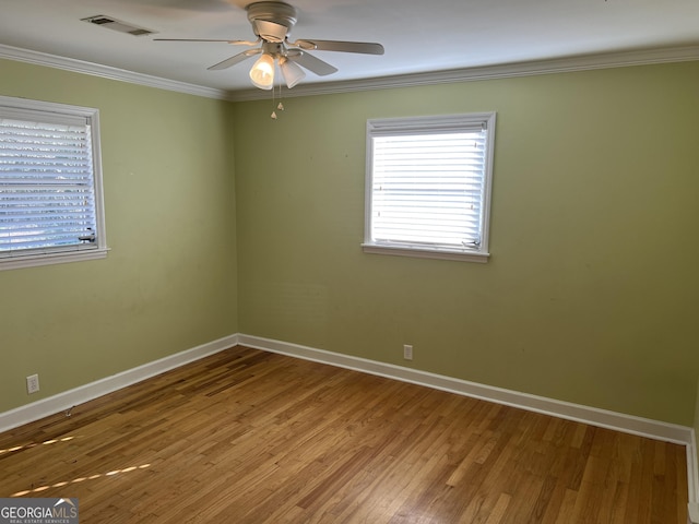 spare room featuring ornamental molding, hardwood / wood-style floors, and ceiling fan