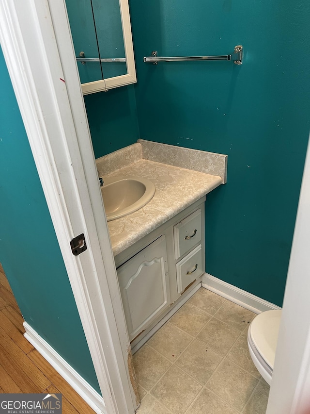 bathroom with vanity, tile patterned flooring, and toilet