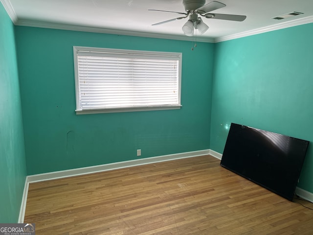 unfurnished room featuring light hardwood / wood-style flooring, ornamental molding, and ceiling fan