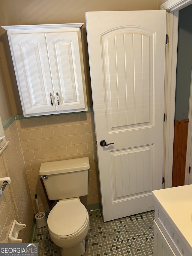 bathroom with tile patterned floors, tile walls, and vanity