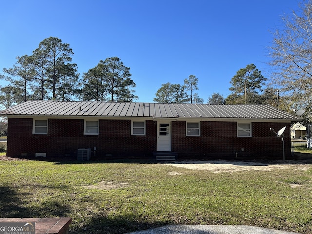 ranch-style home with central AC and a front lawn