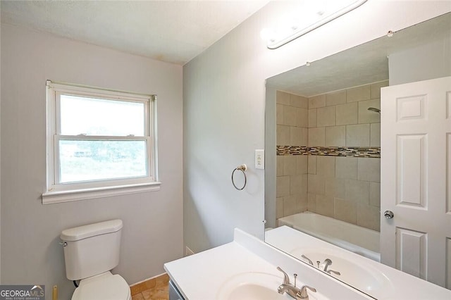 full bathroom featuring tile patterned flooring, vanity, tiled shower / bath combo, and toilet