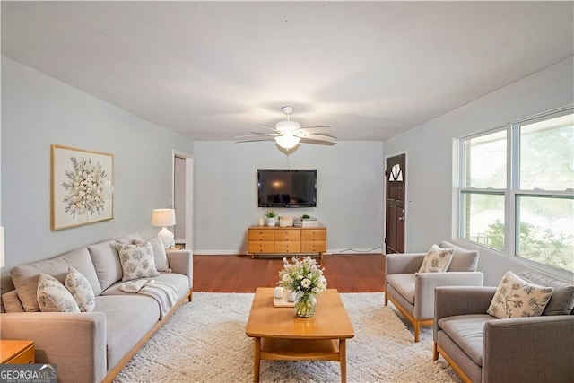 living room featuring ceiling fan and wood-type flooring