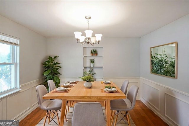 dining room featuring a chandelier, dark hardwood / wood-style flooring, and a wealth of natural light