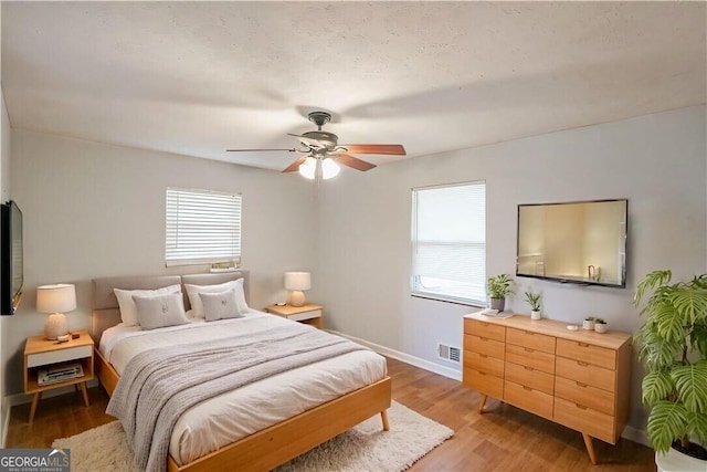 bedroom featuring hardwood / wood-style flooring and ceiling fan