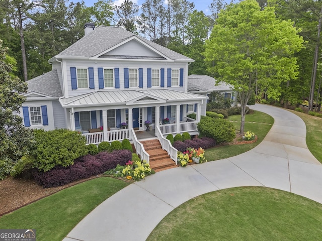 view of front of property with covered porch and a front lawn