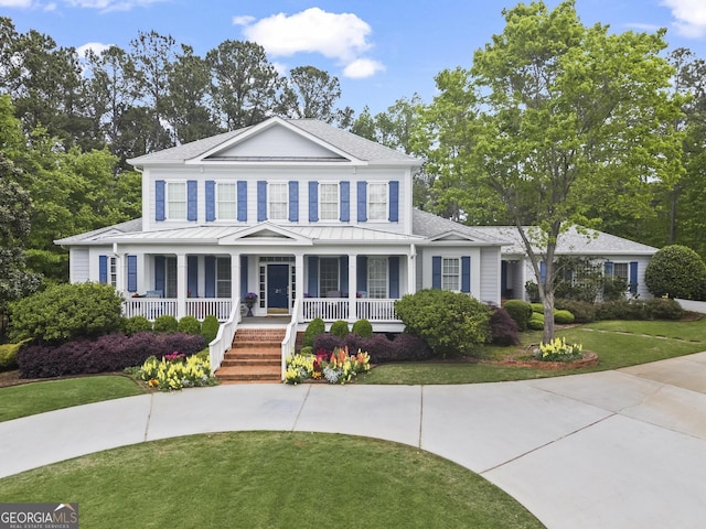 view of front of home featuring covered porch and a front yard