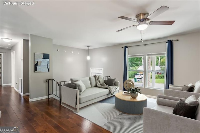 living room with dark hardwood / wood-style floors and ceiling fan