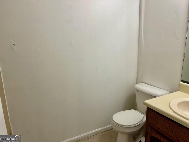 bathroom featuring tile patterned flooring, vanity, and toilet