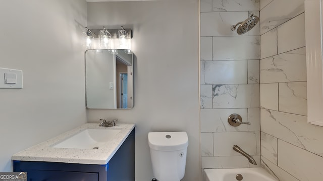 full bathroom with vanity, tiled shower / bath combo, and toilet