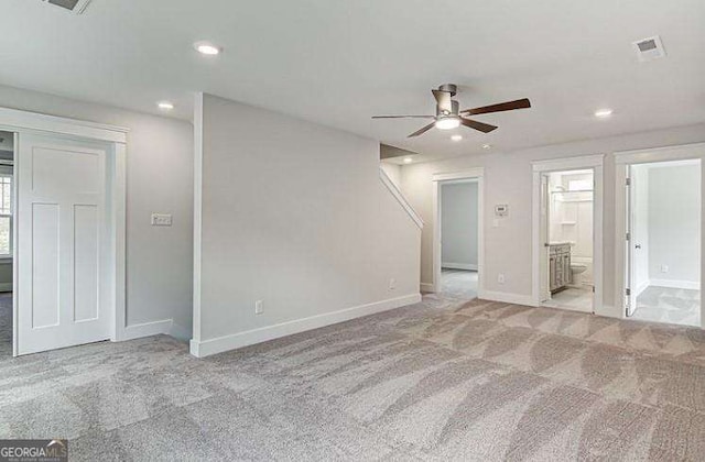 interior space with light colored carpet and ceiling fan