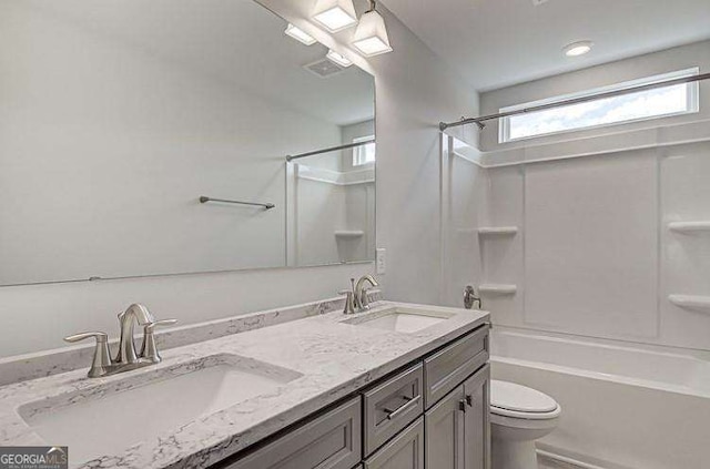 full bathroom with washtub / shower combination, vanity, and toilet