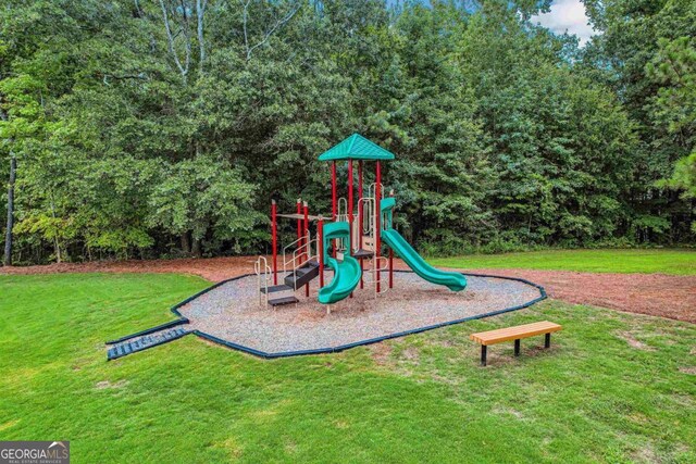 view of playground with a lawn