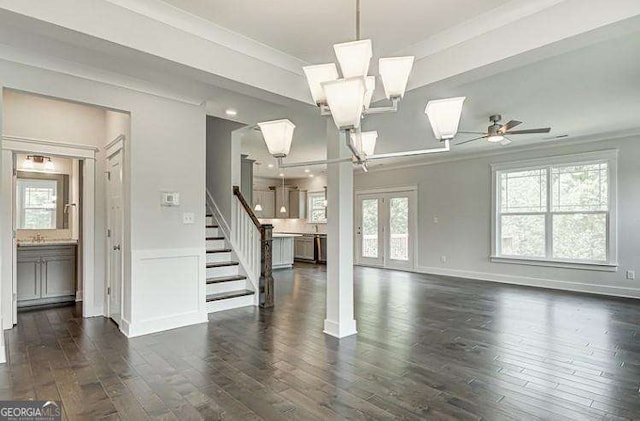 unfurnished living room featuring dark hardwood / wood-style flooring, ceiling fan, plenty of natural light, and crown molding