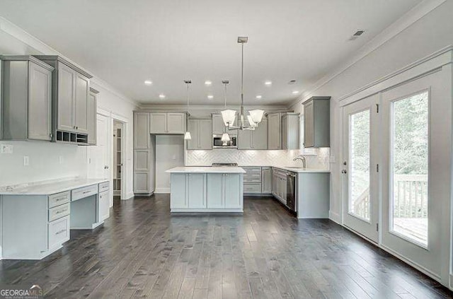 kitchen with gray cabinets, decorative light fixtures, a kitchen island, dark hardwood / wood-style flooring, and stainless steel appliances