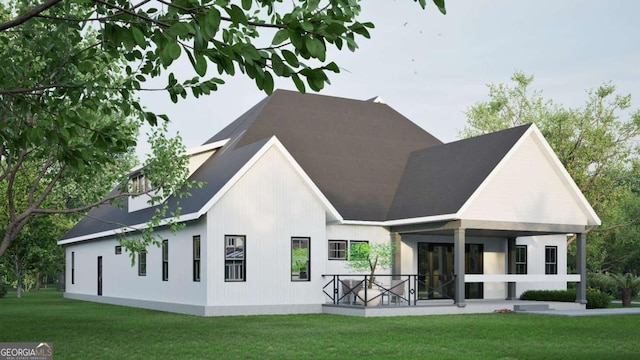 rear view of property featuring a lawn