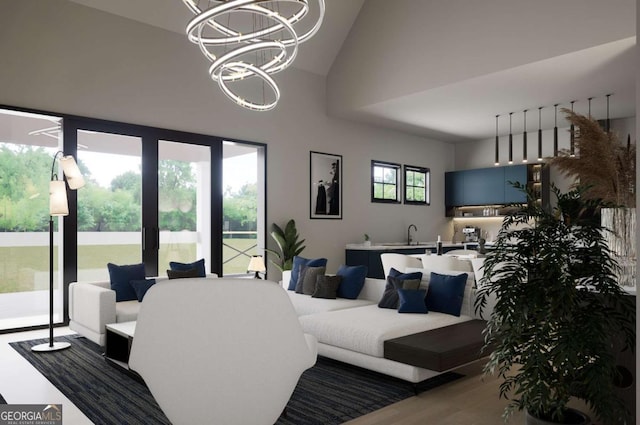 living room featuring plenty of natural light, high vaulted ceiling, hardwood / wood-style floors, and a notable chandelier