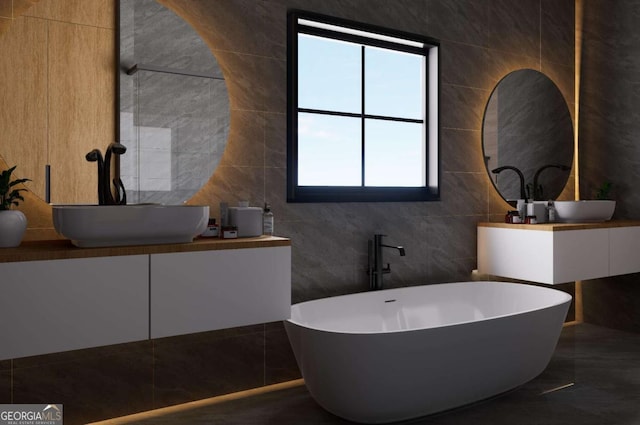 bathroom with vanity, tile walls, and a bathing tub