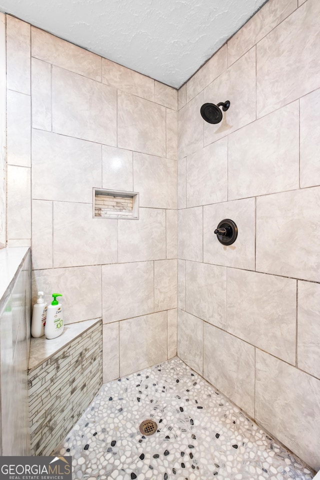 bathroom with a tile shower
