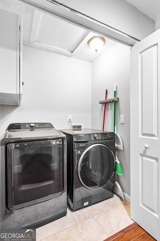 laundry room featuring washer and clothes dryer and light hardwood / wood-style floors