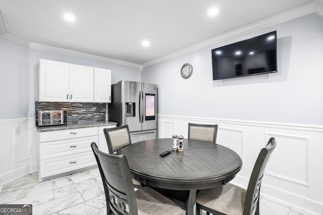 dining space with crown molding