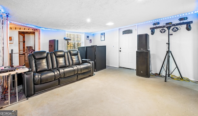 home theater featuring concrete floors and a textured ceiling