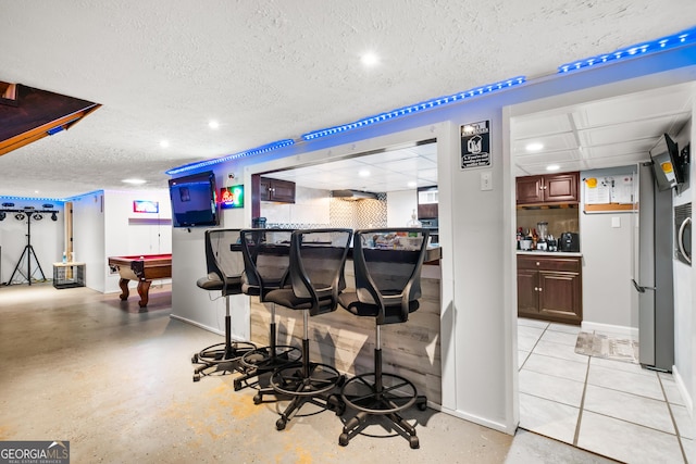 bar featuring a textured ceiling and billiards