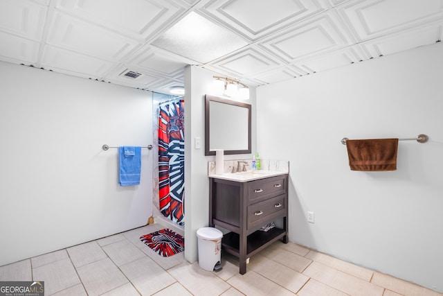 bathroom with curtained shower and vanity