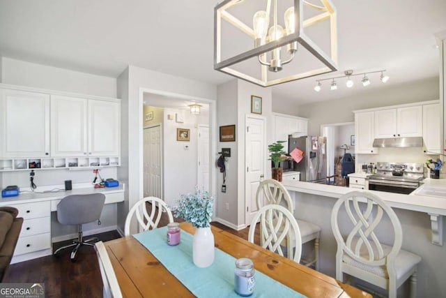 dining space with an inviting chandelier and dark wood-type flooring