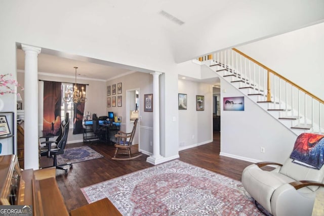 living room with ornamental molding, dark hardwood / wood-style floors, and a notable chandelier