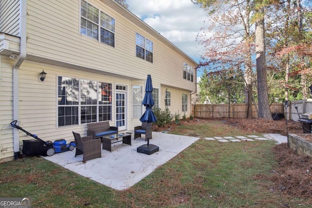 rear view of house with a yard and a patio area