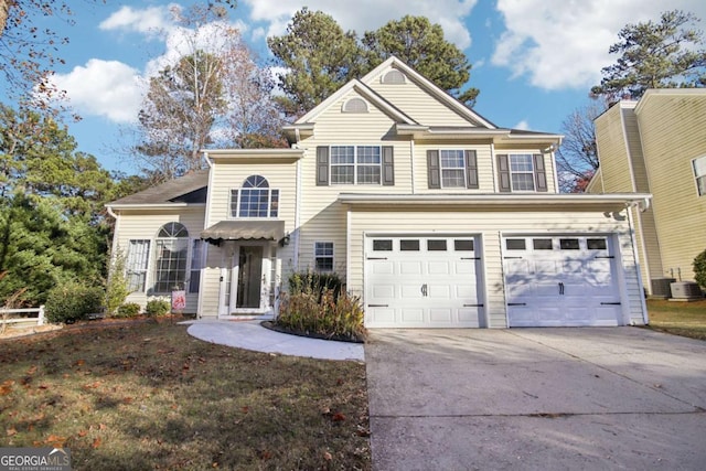 front of property with a garage and central air condition unit