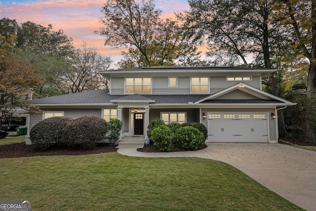 view of front facade with a garage and a lawn