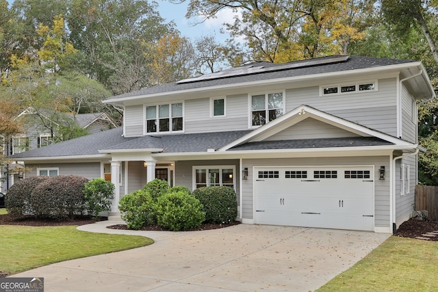 view of front of home with a porch, solar panels, and a garage