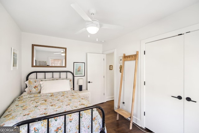 bedroom with a closet, dark hardwood / wood-style floors, and ceiling fan