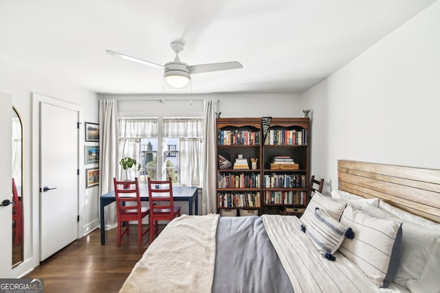 bedroom with dark hardwood / wood-style floors and ceiling fan