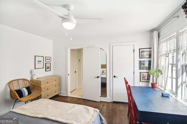 bedroom with ceiling fan and dark hardwood / wood-style floors