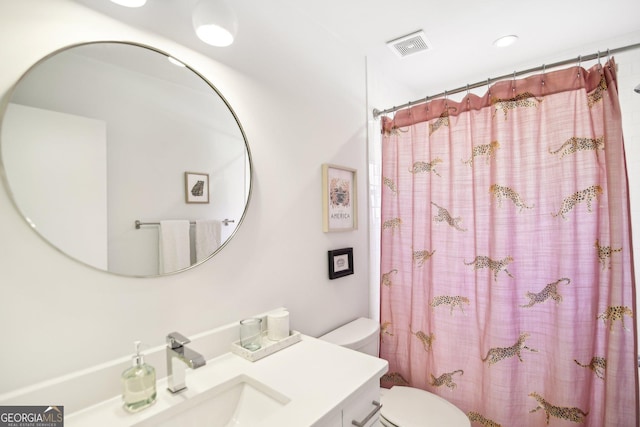 bathroom with a shower with curtain, vanity, and toilet